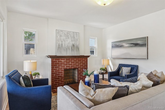 living room with plenty of natural light, wood finished floors, and a fireplace