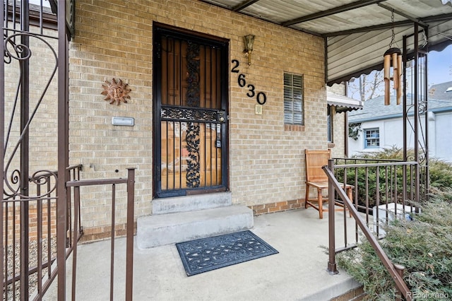 view of exterior entry with brick siding