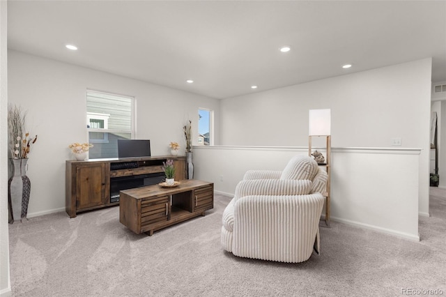 sitting room featuring light colored carpet