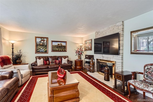 6436 Otis St, Arvada, CO 80003 - living area featuring a stone fireplace and a textured ceiling