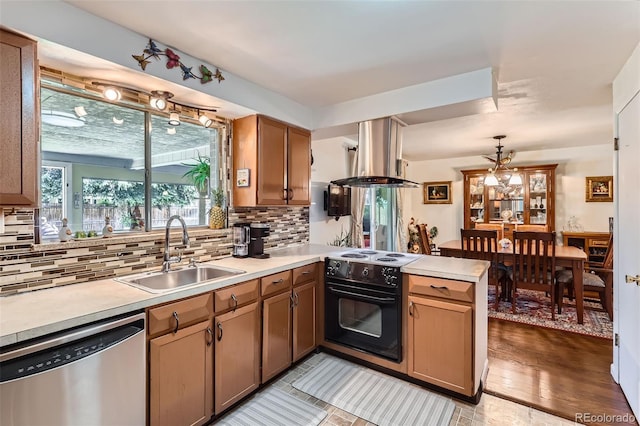 6436 Otis St, Arvada, CO 80003 - kitchen featuring stainless steel dishwasher, black range with electric stovetop, extractor fan, a peninsula, and light countertops