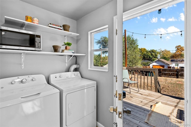 clothes washing area featuring independent washer and dryer and hardwood / wood-style floors