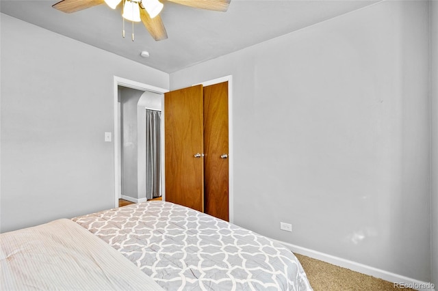 carpeted bedroom featuring a closet and ceiling fan