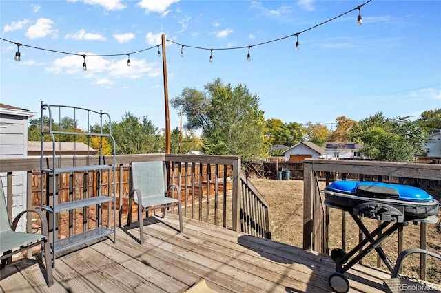 wooden deck featuring a grill