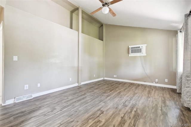 180 S Lamar St, Lakewood, CO 80226 - empty room featuring a wall mounted AC, a ceiling fan, wood finished floors, lofted ceiling, and baseboards