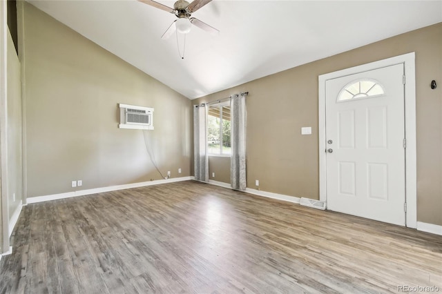 180 S Lamar St, Lakewood, CO 80226 - foyer entrance with ceiling fan, an AC wall unit, wood finished floors, baseboards, and high vaulted ceiling