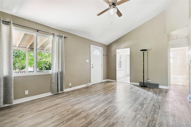 180 S Lamar St, Lakewood, CO 80226 - unfurnished living room featuring a ceiling fan, vaulted ceiling, wood finished floors, and baseboards