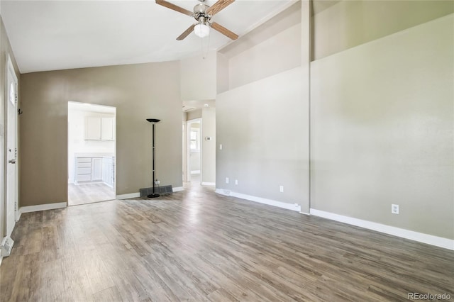 180 S Lamar St, Lakewood, CO 80226 - unfurnished room featuring ceiling fan, baseboards, wood finished floors, and high vaulted ceiling