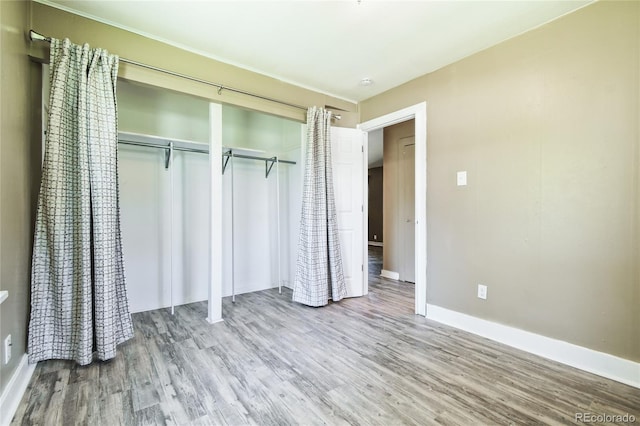 180 S Lamar St, Lakewood, CO 80226 - unfurnished bedroom with wood finished floors, baseboards, and a closet