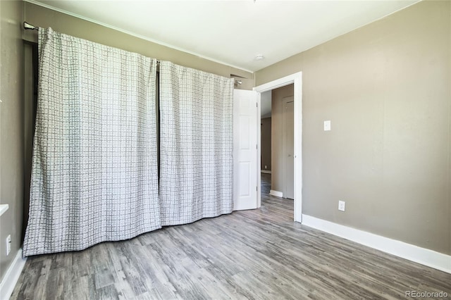 180 S Lamar St, Lakewood, CO 80226 - unfurnished bedroom with wood finished floors and baseboards