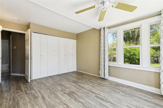 180 S Lamar St, Lakewood, CO 80226 - unfurnished bedroom with baseboards, wood finished floors, a closet, and ceiling fan