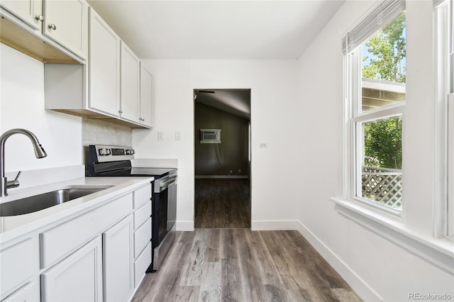 180 S Lamar St, Lakewood, CO 80226 - kitchen featuring stainless steel electric range oven, a sink, light wood-type flooring, and healthy amount of natural light
