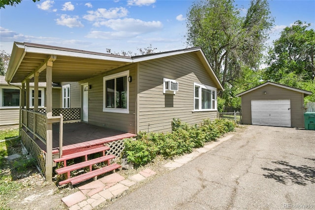 180 S Lamar St, Lakewood, CO 80226 - view of front of property featuring a garage, asphalt driveway, and an outdoor structure