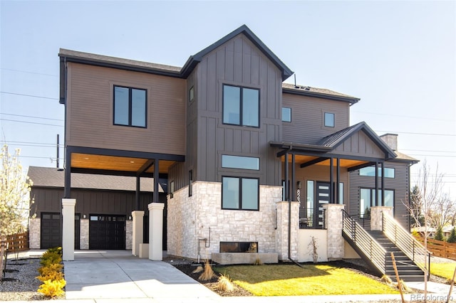 8230 W Tennessee Ct, Lakewood, CO 80226 - modern home featuring board and batten siding, an attached garage, stone siding, and concrete driveway