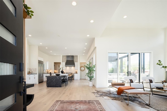 8230 W Tennessee Ct, Lakewood, CO 80226 - living room featuring recessed lighting, light wood-style flooring, and a high ceiling