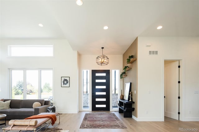 8230 W Tennessee Ct, Lakewood, CO 80226 - entrance foyer with light wood-style flooring, baseboards, a towering ceiling, and recessed lighting