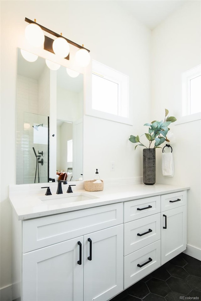 8230 W Tennessee Ct, Lakewood, CO 80226 - bathroom featuring vanity, a tile shower, and tile patterned floors