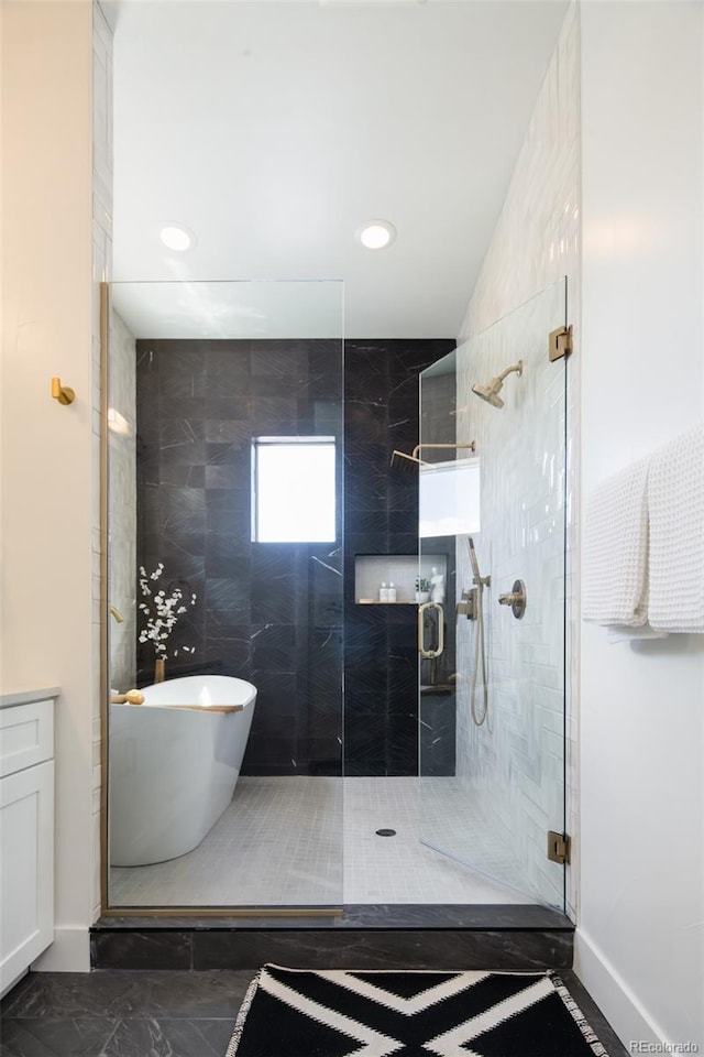 8230 W Tennessee Ct, Lakewood, CO 80226 - bathroom featuring a shower stall, a freestanding tub, recessed lighting, and baseboards