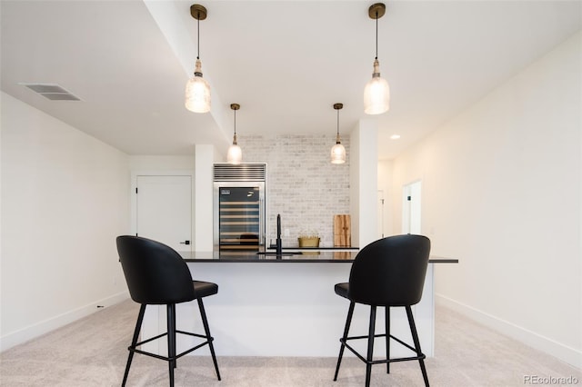 8230 W Tennessee Ct, Lakewood, CO 80226 - kitchen featuring beverage cooler, dark countertops, a breakfast bar, and baseboards