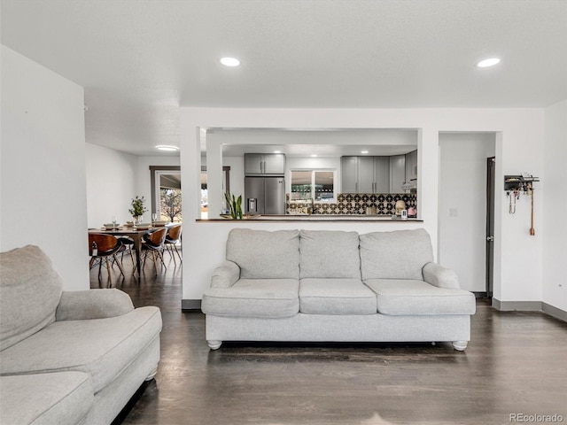 living area with recessed lighting and baseboards