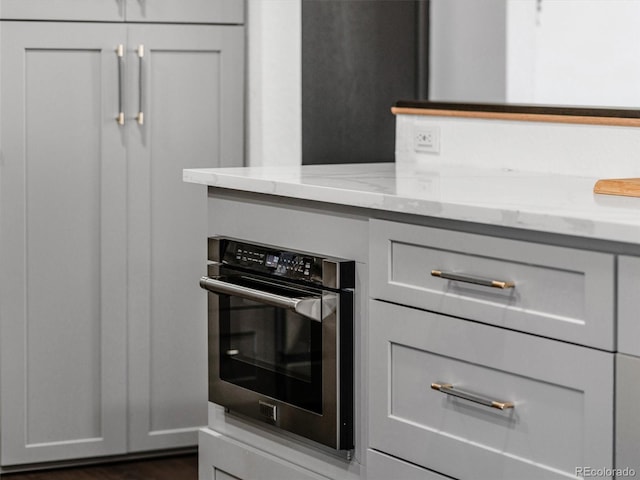 kitchen with light stone counters and oven