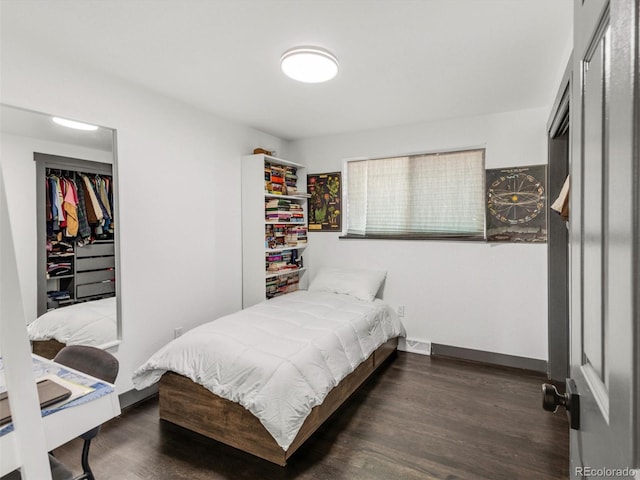 bedroom with visible vents, baseboards, and wood finished floors