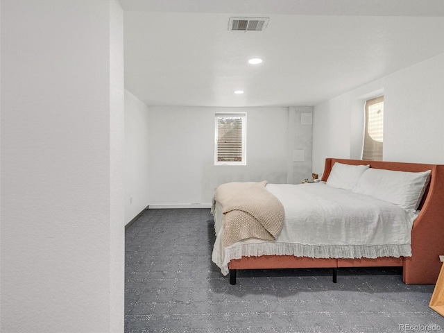 bedroom featuring concrete flooring, recessed lighting, and visible vents