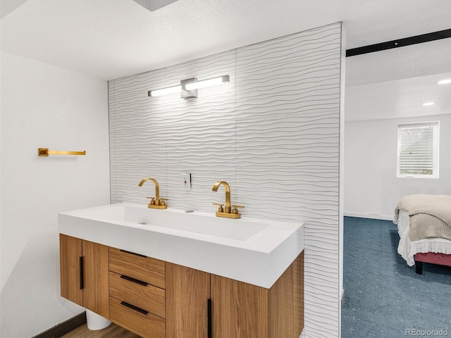 full bathroom featuring baseboards, tile walls, and ensuite bath