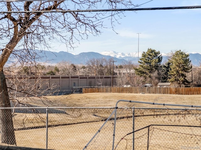 view of yard with fence and a mountain view