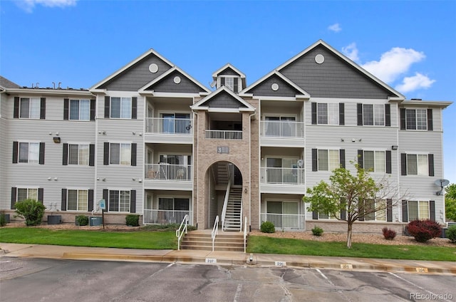 15700 E Jamison Dr Unit 3-307, Englewood, CO 80112 - view of property with central AC and uncovered parking