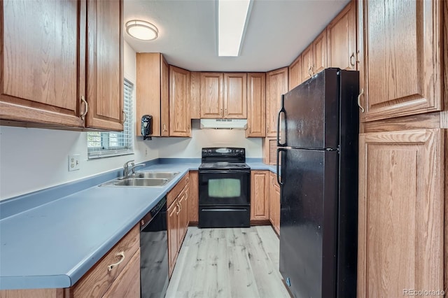 kitchen featuring sink, black appliances, and light wood-type flooring