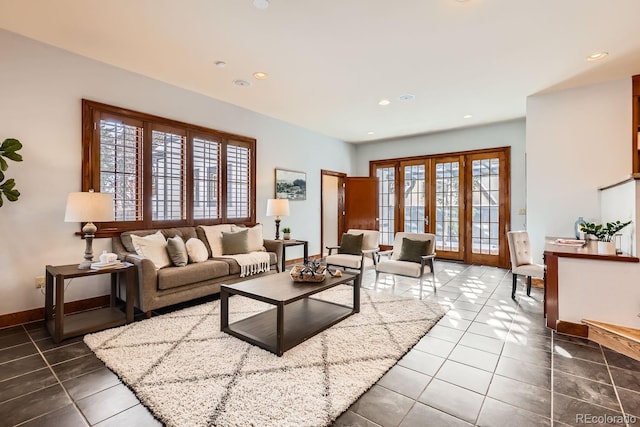 living room with dark tile patterned flooring, french doors, and a healthy amount of sunlight