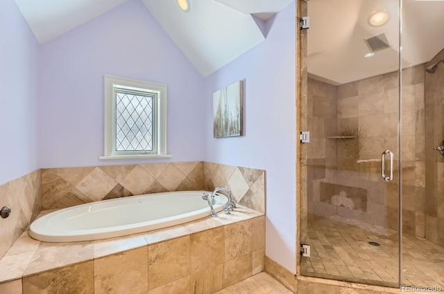 bathroom featuring independent shower and bath and vaulted ceiling