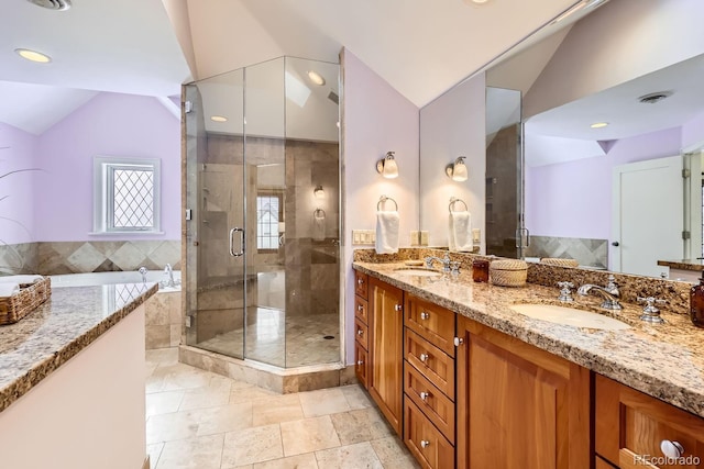 bathroom with a shower with shower door, lofted ceiling, and vanity