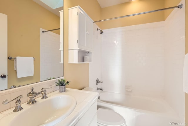 full bathroom featuring toilet, washtub / shower combination, and vanity