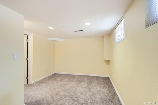 spare room featuring light carpet