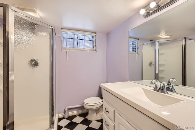 bathroom featuring vanity, toilet, and an enclosed shower