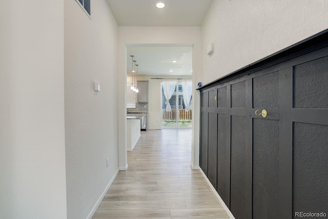 hall with recessed lighting, baseboards, visible vents, and light wood-style floors