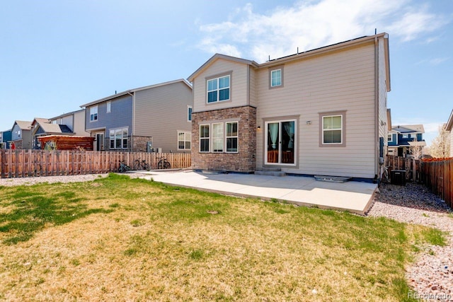 rear view of house featuring a lawn, central AC, a fenced backyard, and a patio area