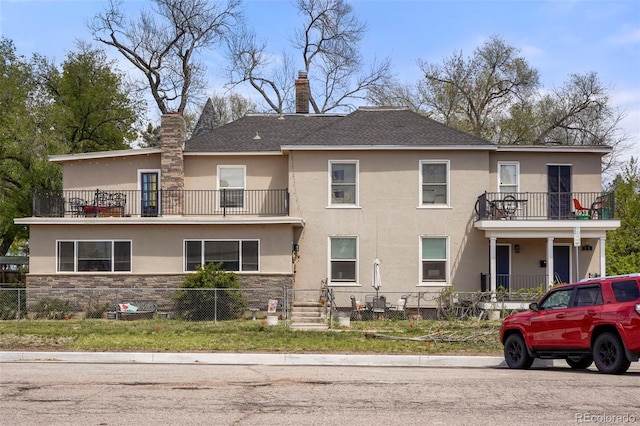 501 N Weber, Colorado Springs, CO 80903 - multi unit property featuring a balcony, a fenced front yard, stucco siding, and a chimney