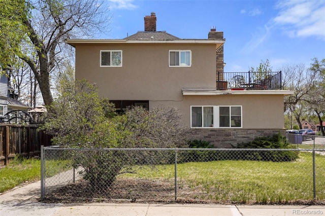 501 N Weber, Colorado Springs, CO 80903 - rear view of property featuring stucco siding, stone siding, and a chimney