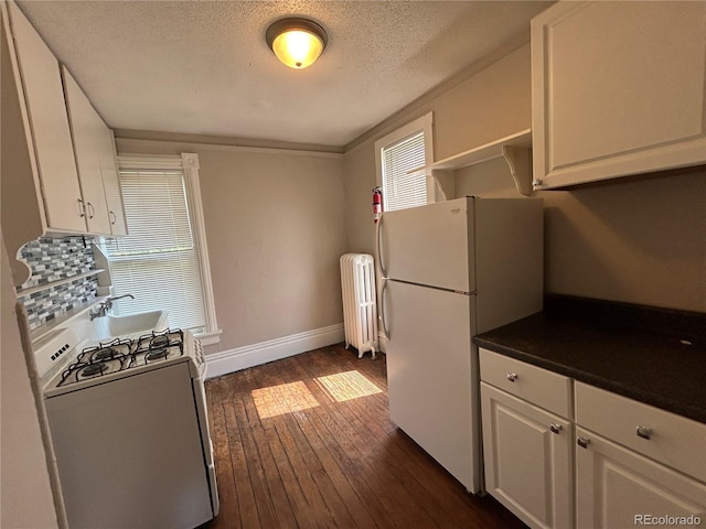 501 N Weber, Colorado Springs, CO 80903 - kitchen with white appliances, radiator, white cabinets, dark wood-style flooring, and a textured ceiling