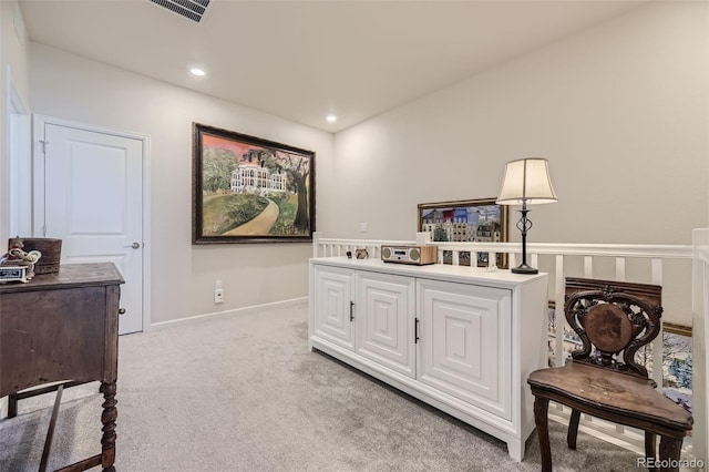 sitting room featuring light colored carpet