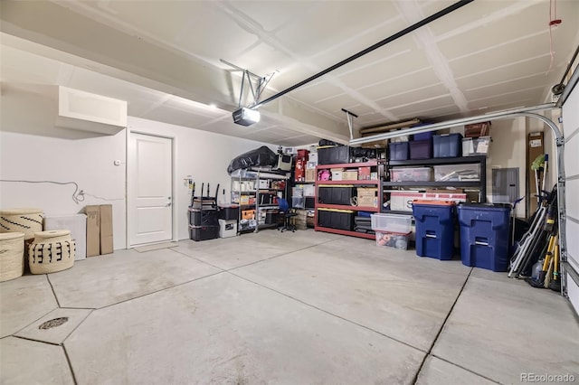 garage with electric panel and a garage door opener