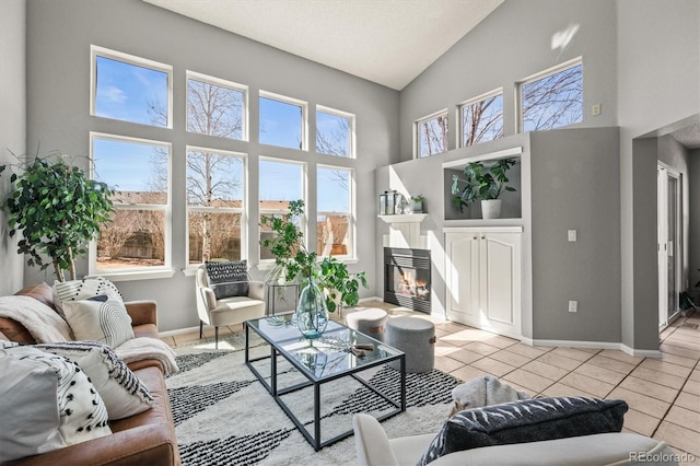 interior space with vaulted ceiling and a glass covered fireplace