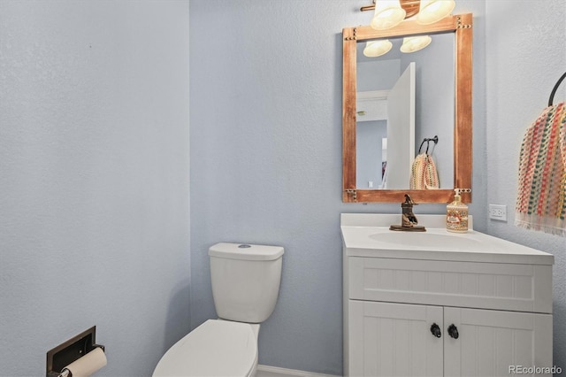 half bath with vanity and toilet