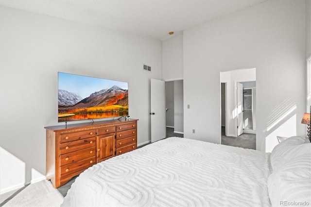 carpeted bedroom featuring high vaulted ceiling, visible vents, and baseboards