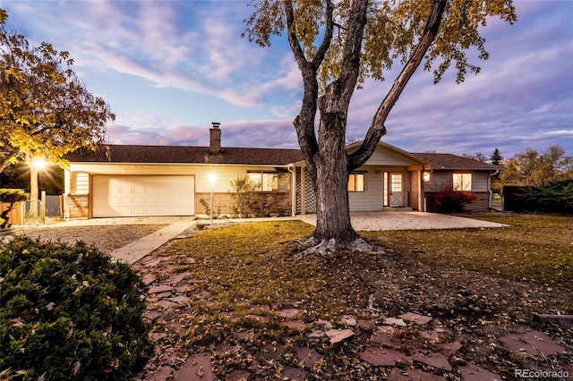 8895 Morton Rd, Niwot, CO 80503 - ranch-style home with dirt driveway, a chimney, brick siding, and an attached garage