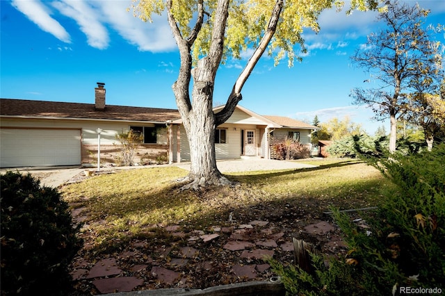 8895 Morton Rd, Niwot, CO 80503 - view of front of house with a garage, a chimney, a front yard, and driveway