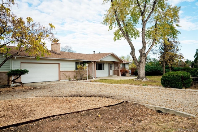 8895 Morton Rd, Niwot, CO 80503 - single story home featuring dirt driveway, a garage, brick siding, and a chimney